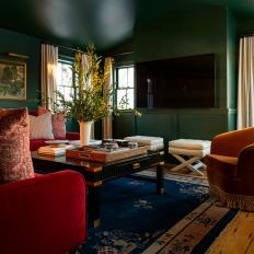 Eclectic Style Living Space With Dark Green Walls and Gio Ponti Seating