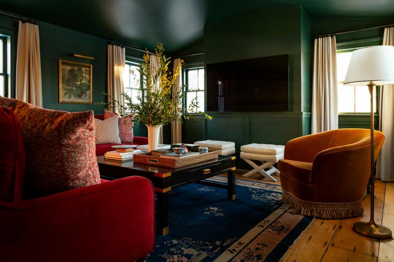 Eclectic style living space with green walls and Gio Ponti seating.