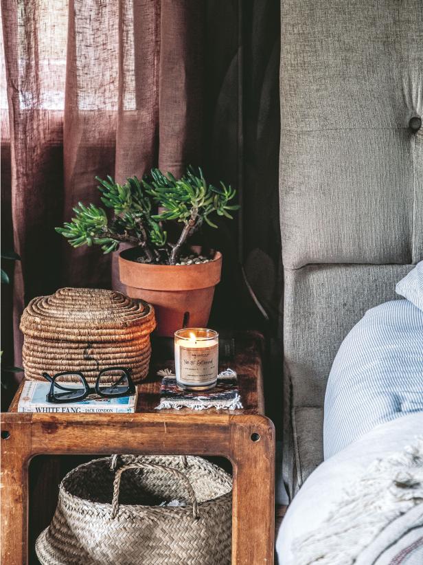 Boho nightstand with a jade plant inside a terracotta flower pot. 