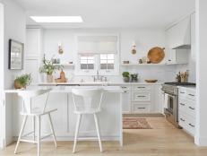 White Kitchen with Island, Marble Counters, Backsplash, Skylight