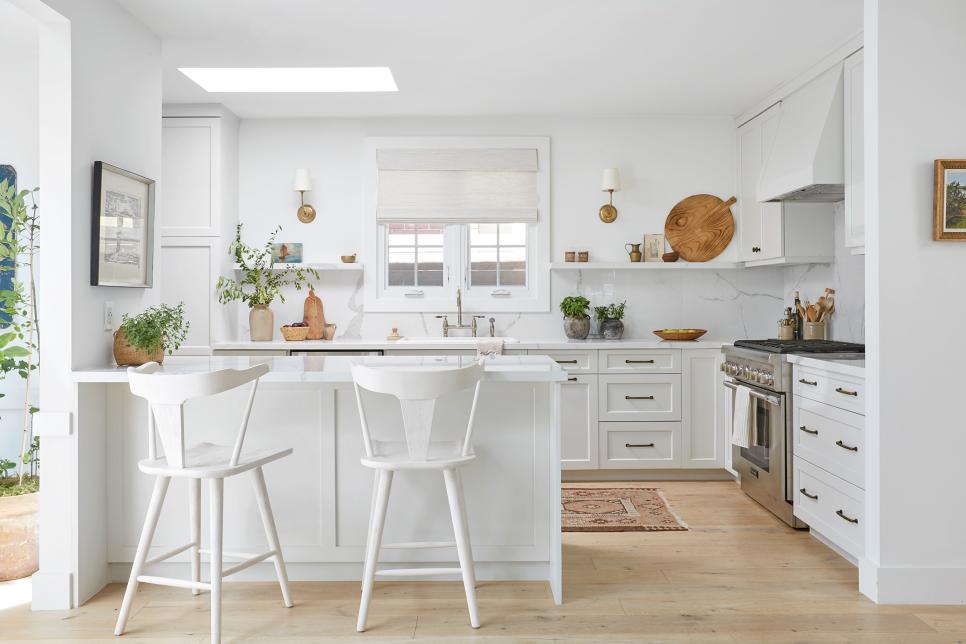 White Kitchen with Island, Marble Counters, Backsplash, Skylight