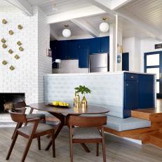 Blue and White Midcentury Modern Dining Area With Fireplace