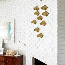 White Brick Fireplace With Gold Fish