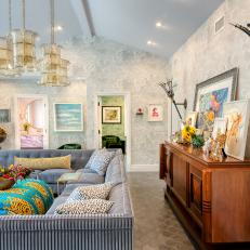 Living Room With Oversized Sconces and Glamorous Blue U-Shaped Sofa