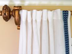 Give plain window treatments major wow factor — the designer way — by adding a leading edge of decorative tape trim to readymade drapery panels; no sewing machine (or designer) required.
