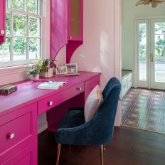 Bright Pink Office Nook With Mesh Accents and Modern Blue Office Chair