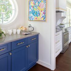 Coffee Bar With Bold Blue Cabinetry And Bright Circular Window