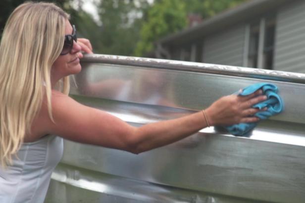Use a rag and paint thinner to clean the outside of the stock tank. Clean several times to remove debris and dirt.