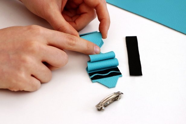 Use hot glue to glue the two bows on top of the crayon shape.