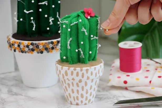 Add pins to your cactus pincushion. Feel free to make these in any size or color you like!