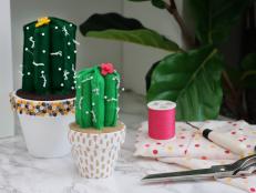 Two green felt cactus pin cushions 