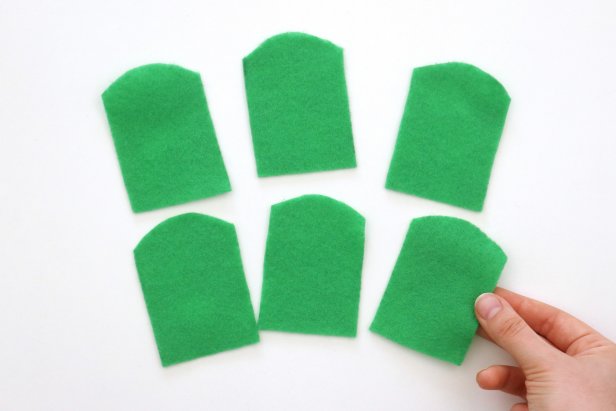 Trace the template onto green felt and cut it out six times.