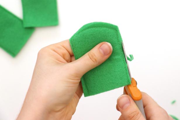 Pair up the felt pieces and sew around the edges, leaving the bottom open. You should end up with three sewn pieces. Trim the edges, being sure not to cut through the thread.