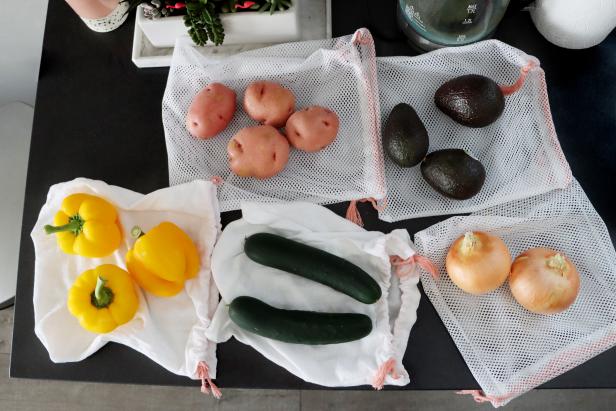 You can use the mesh bags for foods that will be cooked or with inedible rinds (such as avocados or onions), and the cotton bags for foods that are fully edible (such as cucumbers or bell peppers). That way, the food you eat will not come into contact with the shopping cart or conveyor belt.
