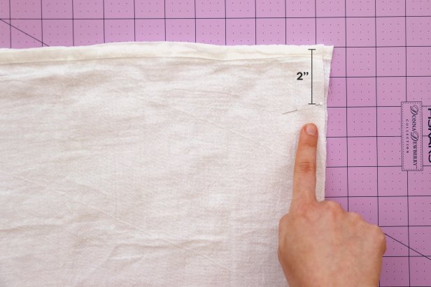 Fold your fabric in half with the right sides facing each other and pin or clip in place. Leave 2” unpinned at the top and mark this spot with a pin.