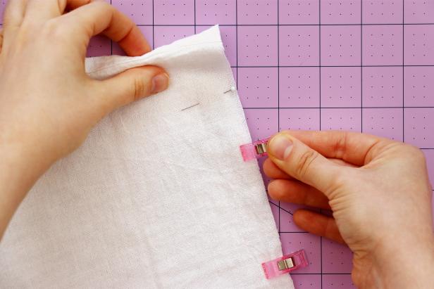 Fold your fabric in half with the right sides facing each other and pin or clip in place. Leave 2” unpinned at the top and mark this spot with a pin.