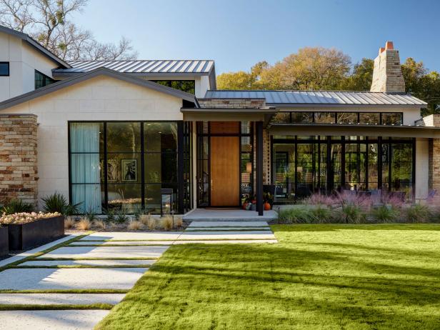 Midcentury exterior with floor-to-ceiling windows and a mix of metal and stone materials