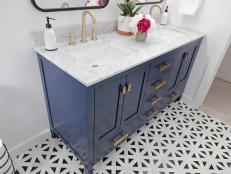 Modern deep blue colored double sink vanity with gold hardware.