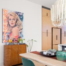 Eclectic Dining Room With Multimedia Art and Vintage Cabinet 