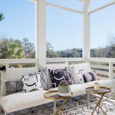 Contemporary Screened Porch With White Sofa, Geometric Rug and Gold Tables 