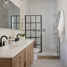 Contemporary Bathroom With Geometric Tile Floor and Bold Black Shower Wall