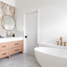 Bathroom With Freestanding Tub and Marble Backsplash