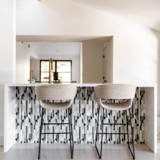 Modern Kitchen Island Features Black and White Tile 