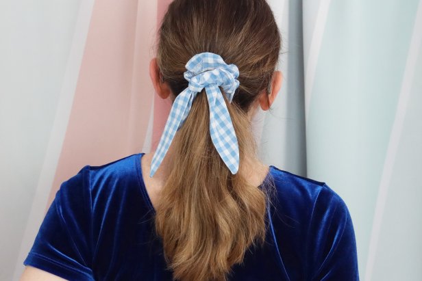 Tie the scarf onto the scrunchie. You can adjust it until you’re happy with how it looks, and since it’s not sewn on, you can wear the scrunchie with or without the scarf.