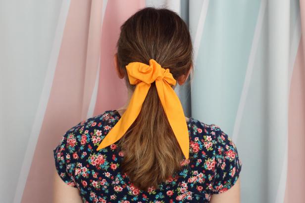 Feel free to make adjustments to this project. To make your scrunchie more voluminous, make your initial rectangle of fabric larger and your elastic shorter. For this example, our fabric rectangle measured 28” x 5” and our elastic measured 6.5”.