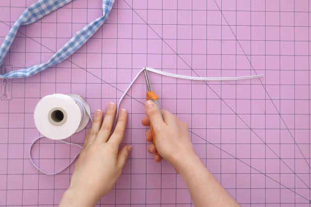 Cut an 8” piece of elastic. Add a safety pin to the end and feed it through the scrunchie. Hand sew the ends of the elastic together. These stitches can be messy and uneven, since it will be hidden inside the scrunchie.