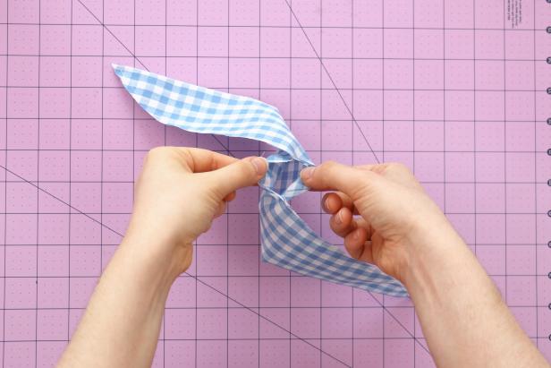 Carefully turn it inside out, pulling each end through the hole left in the center. Use a pencil to make sure the corners are fully pushed out. Press with an iron.
