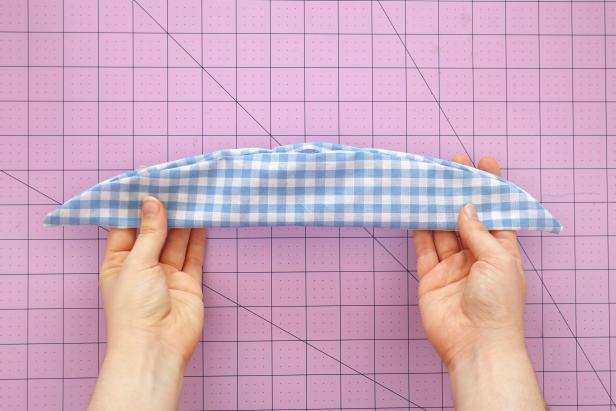 Carefully turn it inside out, pulling each end through the hole left in the center. Use a pencil to make sure the corners are fully pushed out. Press with an iron.