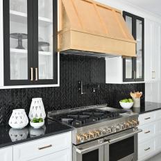 Black and White Contemporary Kitchen With Gold Range Hood