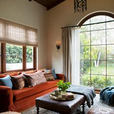 Mediterranean Style Living Space With Bold Red Sofa and Leather Ottomans 