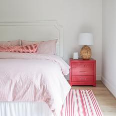 Pink and White Transitional Bedroom With Striped Rug