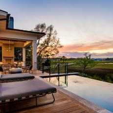 Contemporary Covered Deck and Lounging Area With Infinity Pool