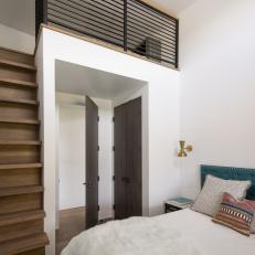 Bright Bedroom Features a Modern Loft and Staircase