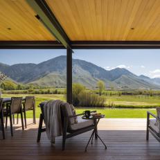 Covered Patio With Dining Table and Lounge Furniture