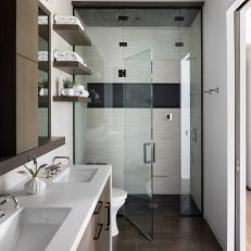 Modern Bathroom With Floating Shelves and a Walk-In Shower