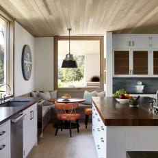 Eclectic, Contemporary White Kitchen With Wide Island and Wooden Plank Ceiling 