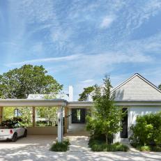 Modern Coastal Home With White Shingles and Covered Carport