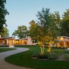 Curving Driveway and Midcentury Home at Twilight