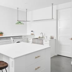 White Laundry Room With Wood Stool