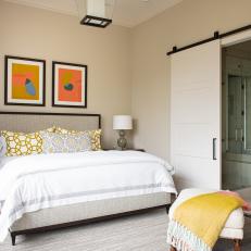 Transitional Bedroom With Vivid Artwork and Black Accents 
