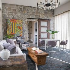 Eclectic Contemporary Sitting Room With Stone Feature Wall and Colorful Art 