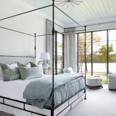Contemporary Coastal Bedroom With Pastel Accents and Bold Black Hardware 