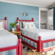 Coastal Kids' Bedroom With Blue Walls and Red Accents 