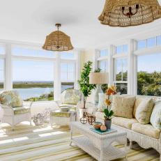 Coastal Sunroom With Wicker Chandeliers and Furniture 