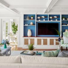 White Coastal Living Room With Blue Entertainment Center and Coffered Ceiling