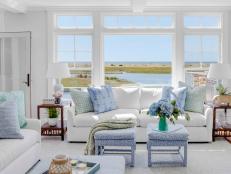 White living room with coastal views and white furniture. 
